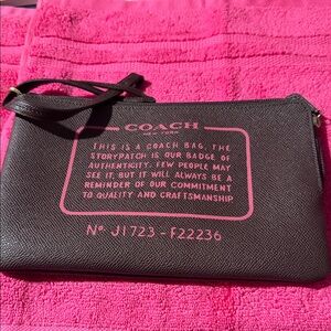 Coach Dark Brown Wristlet with Pink Text
